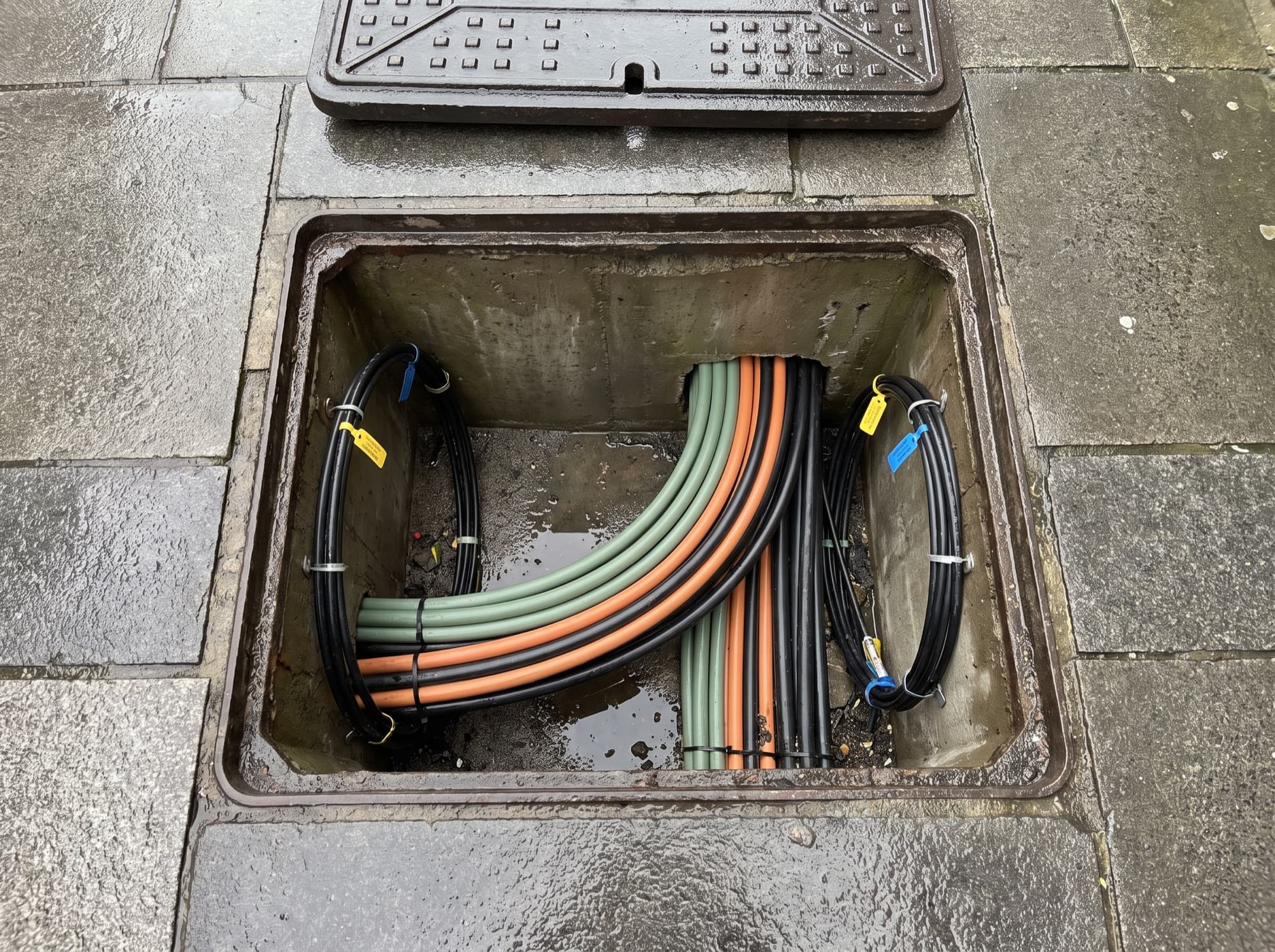 An open footway chamber with coiled sub-duct and fibre routed through it